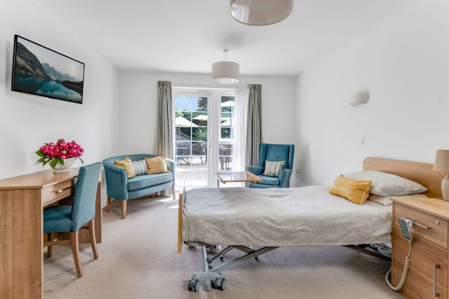 A bedroom at Downs House with doors opening onto the garden